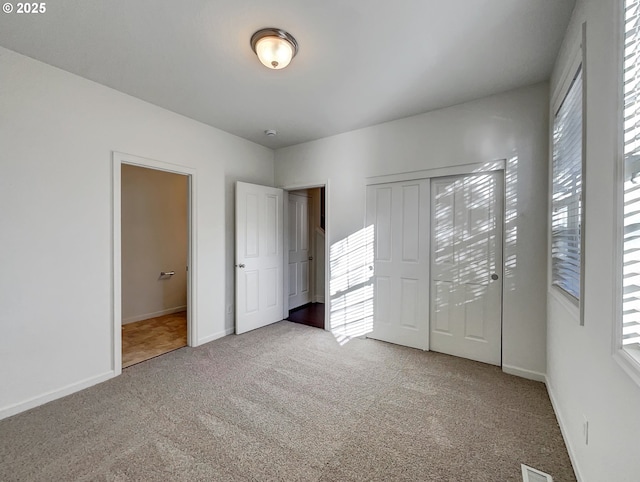 unfurnished bedroom featuring baseboards and carpet flooring