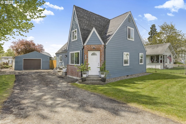 255 W F St, Halsey, OR 97348 - english style home with an outbuilding, a detached garage, a shingled roof, driveway, and brick siding