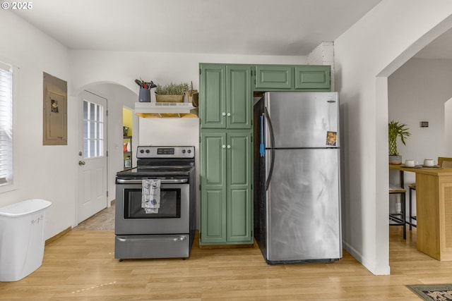 255 W F St, Halsey, OR 97348 - kitchen featuring stainless steel appliances, arched walkways, green cabinetry, light wood-style flooring, and under cabinet range hood