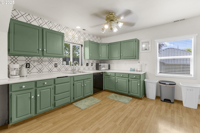 255 W F St, Halsey, OR 97348 - kitchen featuring a sink, black dishwasher, white microwave, and tasteful backsplash