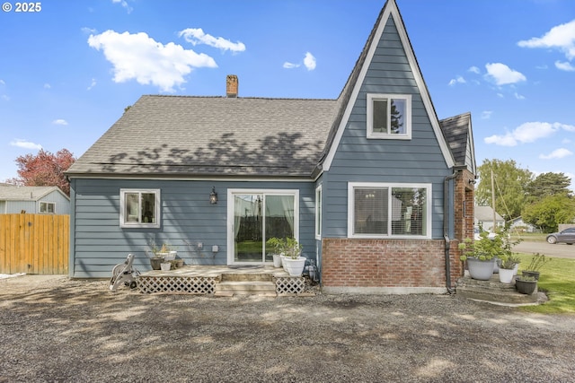 255 W F St, Halsey, OR 97348 - rear view of property featuring a chimney, fence, brick siding, and a shingled roof