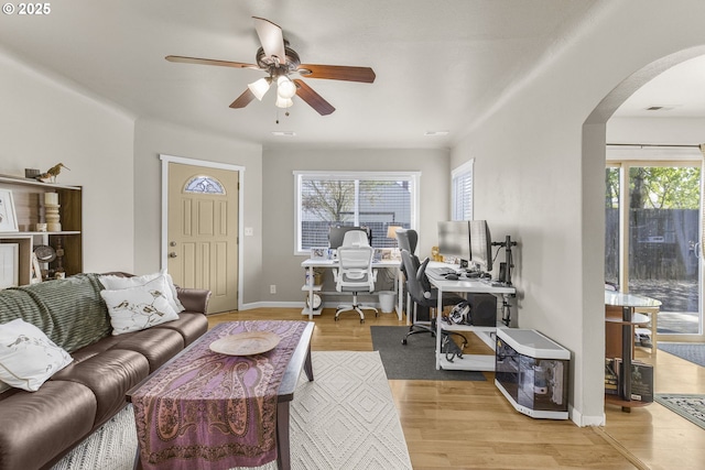 255 W F St, Halsey, OR 97348 - living area with arched walkways, an office area, a ceiling fan, wood finished floors, and baseboards