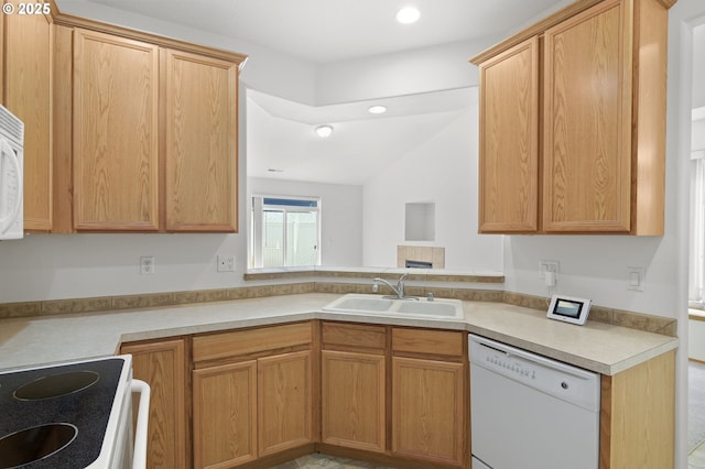 kitchen featuring a sink, light countertops, recessed lighting, and white appliances