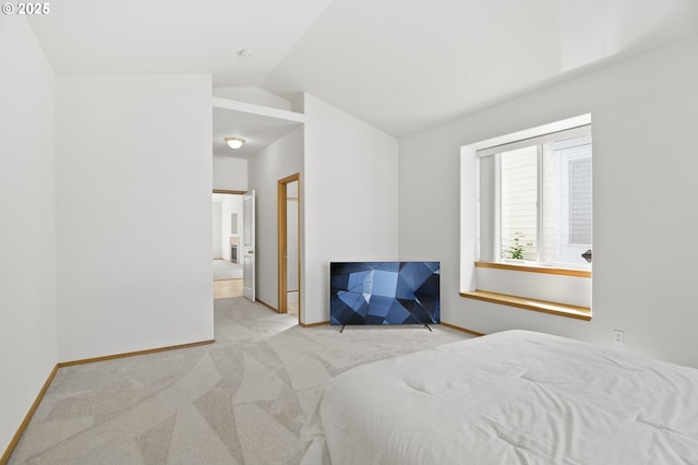 bedroom with baseboards, carpet flooring, and lofted ceiling