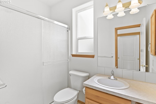 bathroom with an enclosed shower, toilet, and vanity