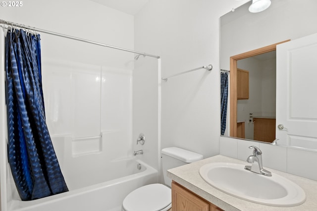 full bathroom featuring vanity, shower / bath combo with shower curtain, and toilet