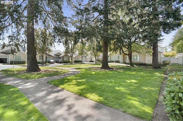 view of yard featuring fence and a residential view