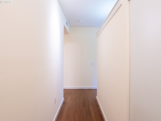 hallway with dark wood-type flooring