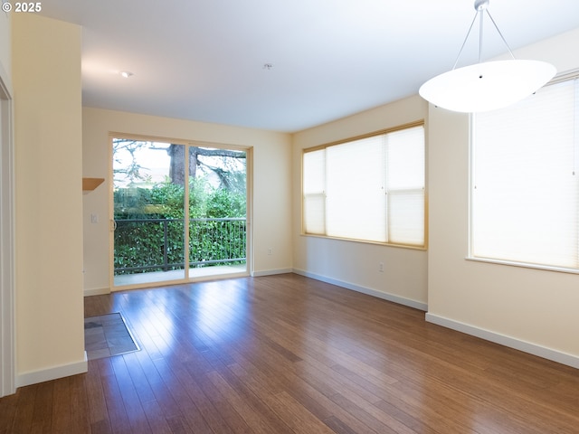 empty room featuring hardwood / wood-style floors and a healthy amount of sunlight