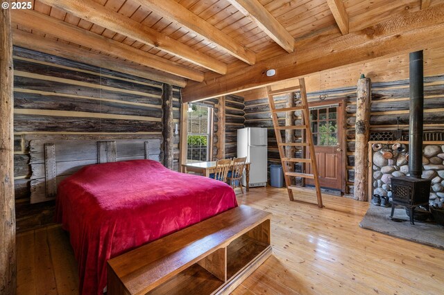 0 Hwy 395, Mount Vernon, OR 97865 - bedroom with freestanding refrigerator, rustic walls, a wood ceiling with exposed beams, hardwood / wood-style floors, and a wood stove
