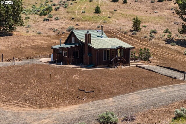 0 Hwy 395, Mount Vernon, OR 97865 - view of front of home featuring board and batten siding, a metal roof, a chimney, and a rural view