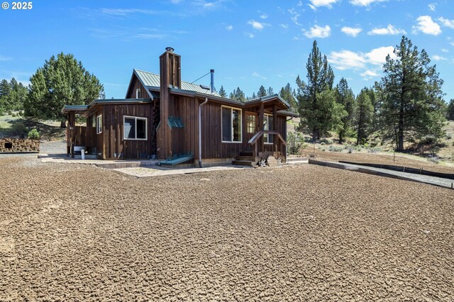 0 Hwy 395, Mount Vernon, OR 97865 - view of home's exterior featuring a chimney, board and batten siding, and a metal roof