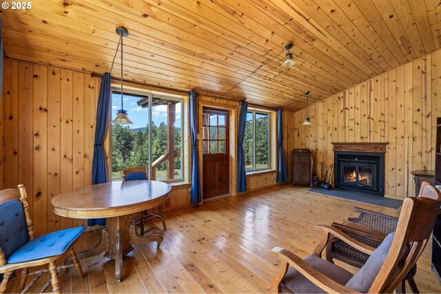 0 Hwy 395, Mount Vernon, OR 97865 - dining area featuring wood ceiling, wooden walls, wood-type flooring, a glass covered fireplace, and vaulted ceiling