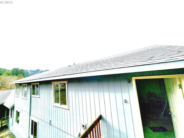 view of home's exterior with roof with shingles