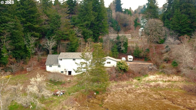 drone / aerial view featuring a forest view
