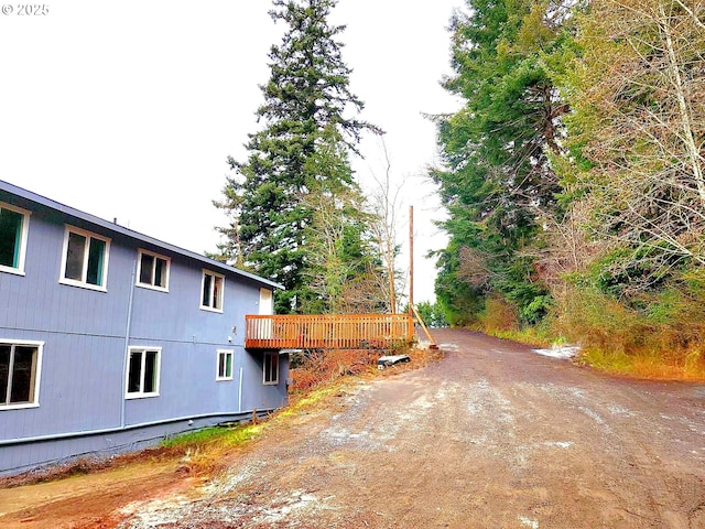 view of home's exterior featuring a wooden deck