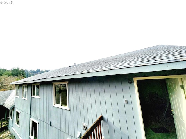 view of property exterior featuring a shingled roof