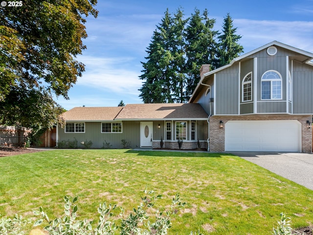 907 NW 90th St, Vancouver, WA 98665 - view of front of house featuring a chimney, an attached garage, asphalt driveway, and brick siding