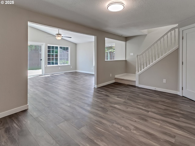907 NW 90th St, Vancouver, WA 98665 - unfurnished living room with dark wood-style floors, ceiling fan, a textured ceiling, vaulted ceiling, and stairway