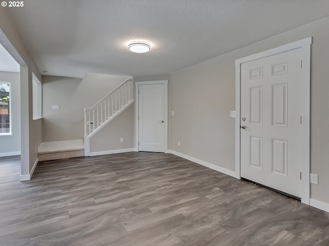 907 NW 90th St, Vancouver, WA 98665 - unfurnished living room featuring a textured ceiling, stairway, and wood finished floors