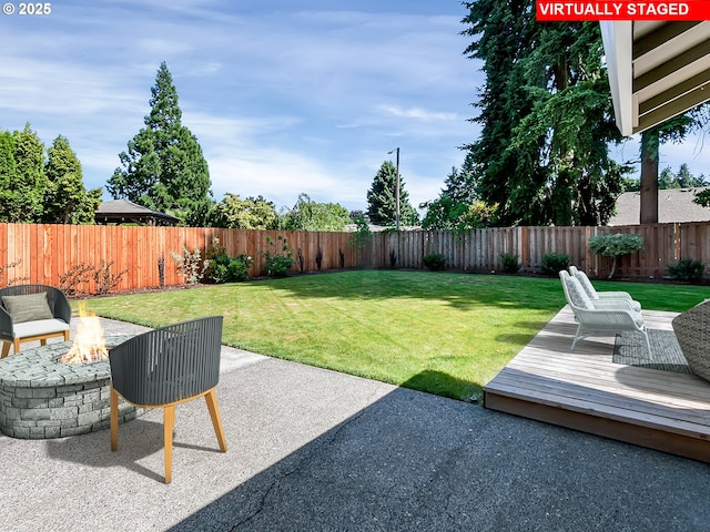 907 NW 90th St, Vancouver, WA 98665 - fenced backyard with a fire pit, a wooden deck, and a patio area