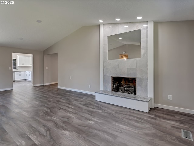907 NW 90th St, Vancouver, WA 98665 - unfurnished living room featuring dark wood-type flooring, vaulted ceiling, a fireplace, and recessed lighting