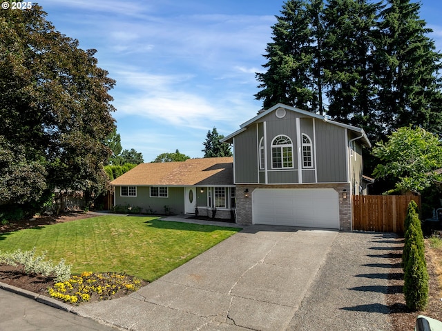 907 NW 90th St, Vancouver, WA 98665 - tri-level home with concrete driveway, a garage, and brick siding