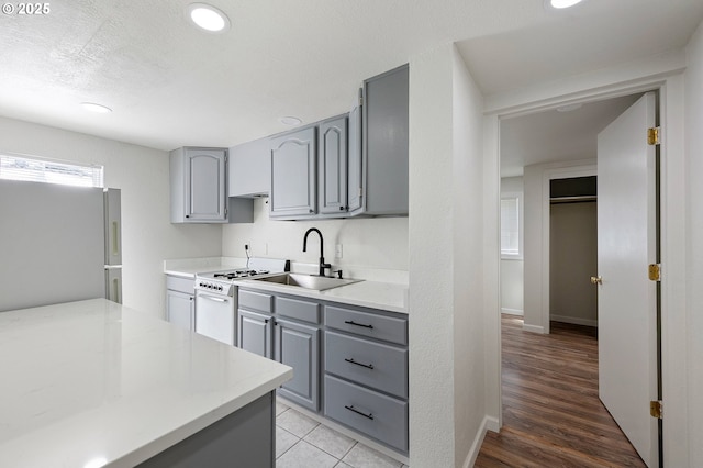 2745 C St, Springfield, OR 97477 - kitchen with gray cabinets, white appliances, a sink, light countertops, and recessed lighting