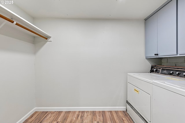 2745 C St, Springfield, OR 97477 - laundry room featuring washer and dryer, cabinet space, light wood-style flooring, and baseboards