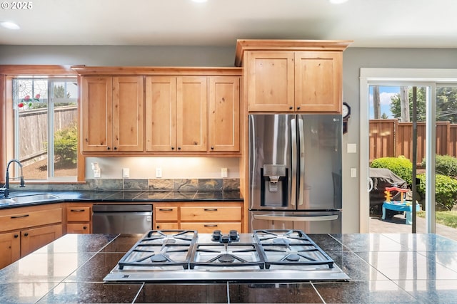 14390 SW Connor Pl, Portland, OR 97224 - kitchen with appliances with stainless steel finishes, tile counters, plenty of natural light, light brown cabinetry, and recessed lighting
