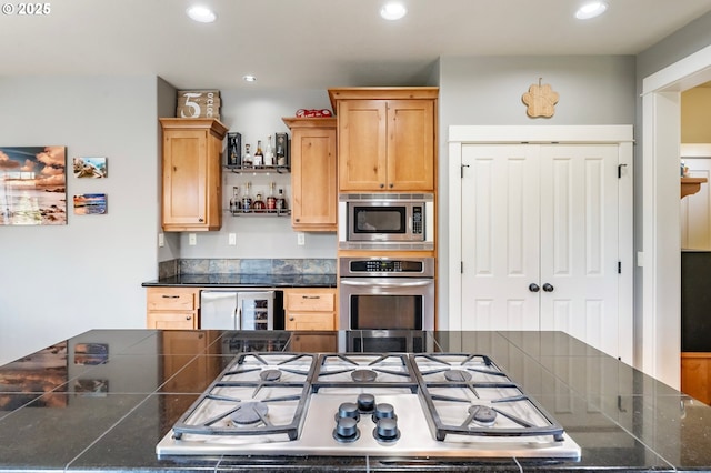 14390 SW Connor Pl, Portland, OR 97224 - kitchen with stainless steel appliances, recessed lighting, light brown cabinets, and tile counters