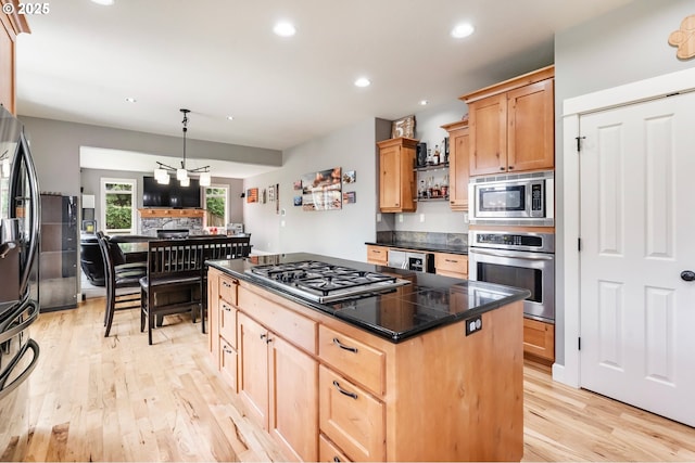14390 SW Connor Pl, Portland, OR 97224 - kitchen with appliances with stainless steel finishes, light wood finished floors, a center island, light brown cabinets, and recessed lighting