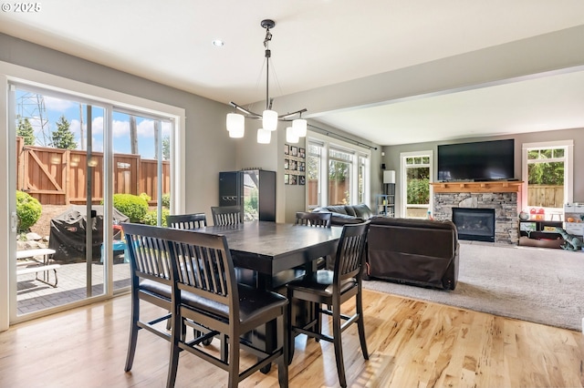 14390 SW Connor Pl, Portland, OR 97224 - dining space with a fireplace, light wood-type flooring, recessed lighting, and a chandelier