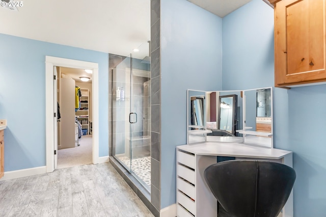 14390 SW Connor Pl, Portland, OR 97224 - bathroom featuring wood finished floors, a shower stall, and vanity