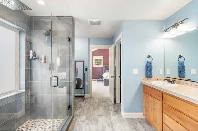 14390 SW Connor Pl, Portland, OR 97224 - ensuite bathroom with wood finished floors, a stall shower, and vanity