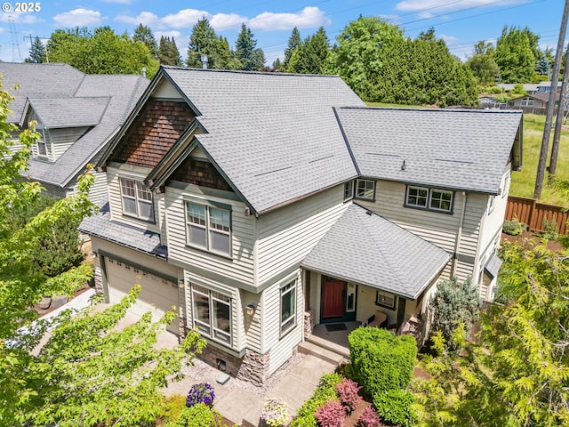 14390 SW Connor Pl, Portland, OR 97224 - rear view of house featuring an attached garage, a porch, and a shingled roof