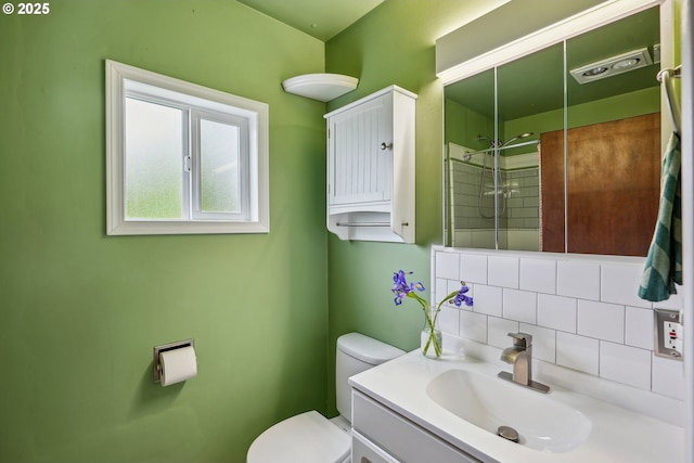 full bath featuring vanity, decorative backsplash, walk in shower, and toilet