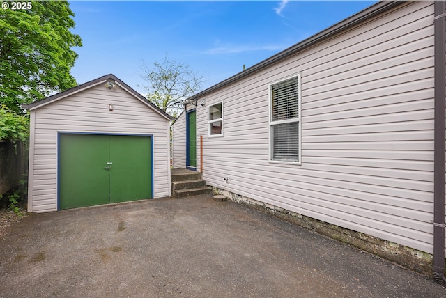 detached garage featuring a shed