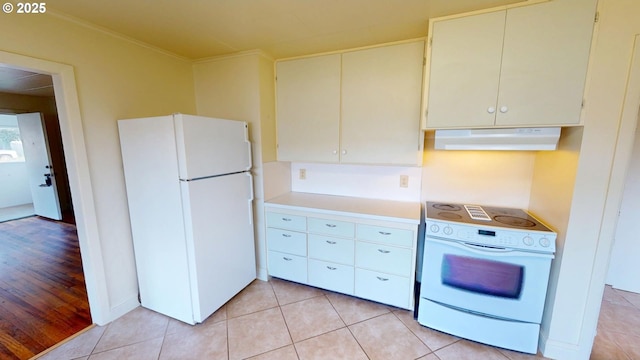 kitchen with light tile patterned flooring and white appliances