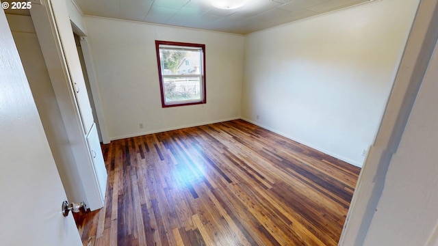 unfurnished room featuring crown molding and dark hardwood / wood-style floors