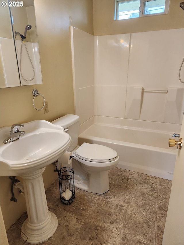 bathroom featuring shower / bathtub combination and toilet