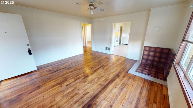 unfurnished room with ceiling fan and light wood-type flooring