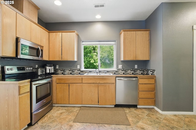 18522 SW Mcclarey Dr, Beaverton, OR 97007 - kitchen featuring appliances with stainless steel finishes, a sink, backsplash, light brown cabinetry, and recessed lighting