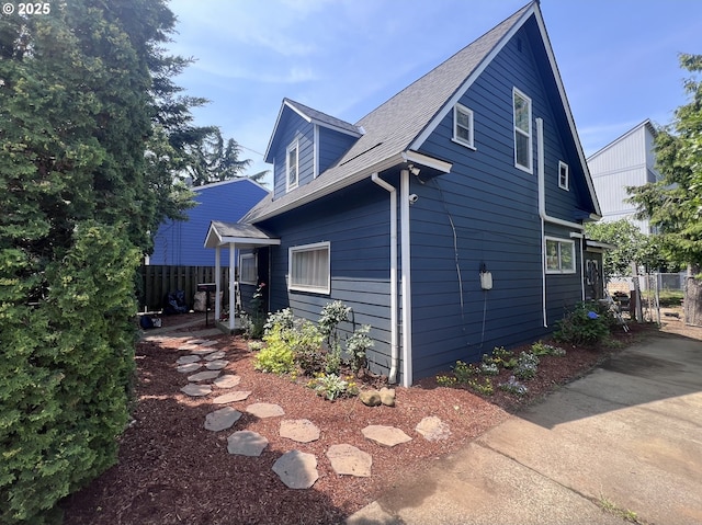 5843 SE 90th Ave, Portland, OR 97266 - view of side of home featuring a shingled roof