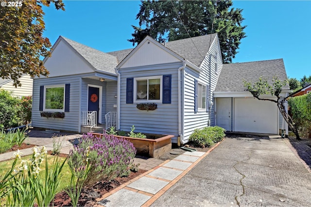4580 NE 35th Pl, Portland, OR 97211 - bungalow-style house featuring a shingled roof, asphalt driveway, and a garage