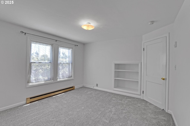 4580 NE 35th Pl, Portland, OR 97211 - empty room with a baseboard heating unit, carpet flooring, baseboards, and built in shelves