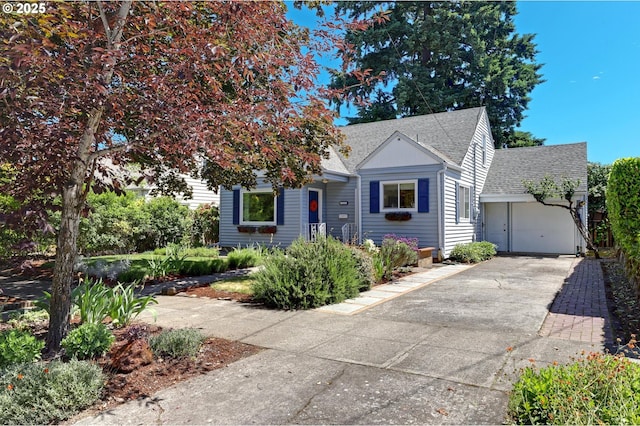 4580 NE 35th Pl, Portland, OR 97211 - bungalow-style home featuring concrete driveway, roof with shingles, and an attached garage