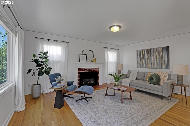 4580 NE 35th Pl, Portland, OR 97211 - living area featuring light wood-type flooring, plenty of natural light, baseboards, and a fireplace