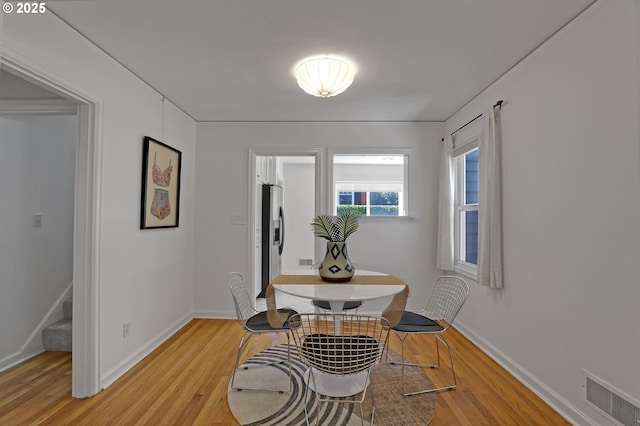 4580 NE 35th Pl, Portland, OR 97211 - dining room featuring light wood finished floors, baseboards, and stairway