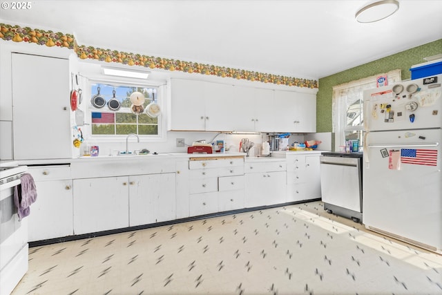 kitchen with white cabinetry, sink, and white appliances